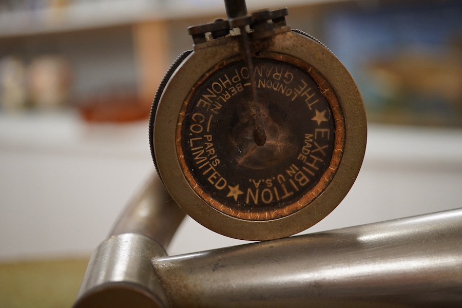 An HMV tabletop mahogany gramophone player with large laminated wooden horn, diameter of horn 55cm. HMV transfer labels to both body and horn. Condition - fair.